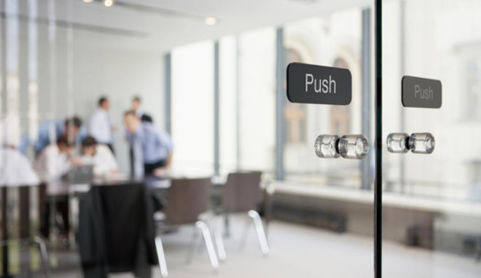 Office meeting behind glass doors