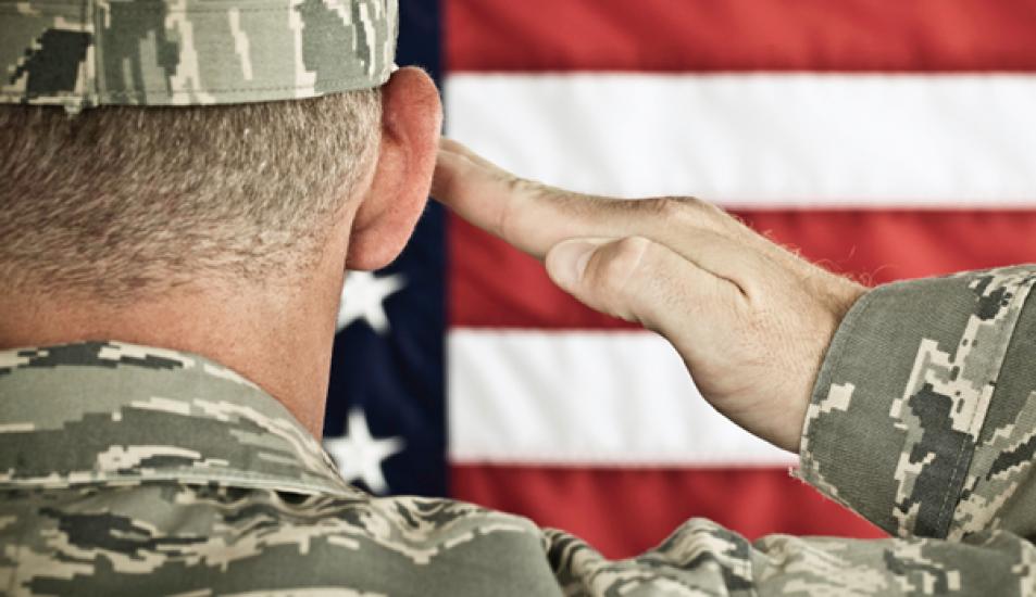 Military soldier saluting American flag