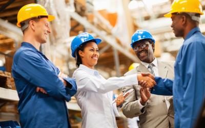 warehouse manager shaking hands with warehouse worker